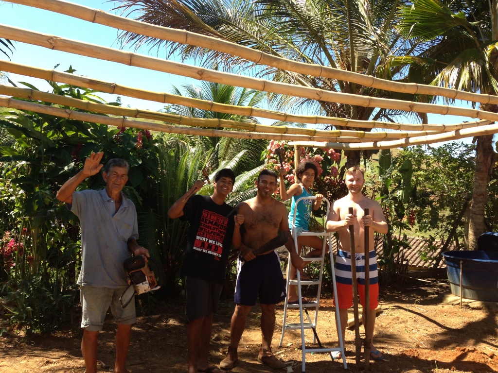 Family in Brazil posing with a cabana being built