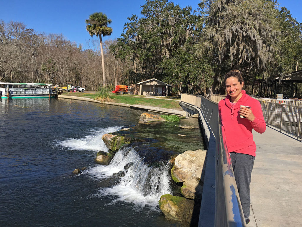 Emille taking a sip of her coffee overlooking De Leon Spring