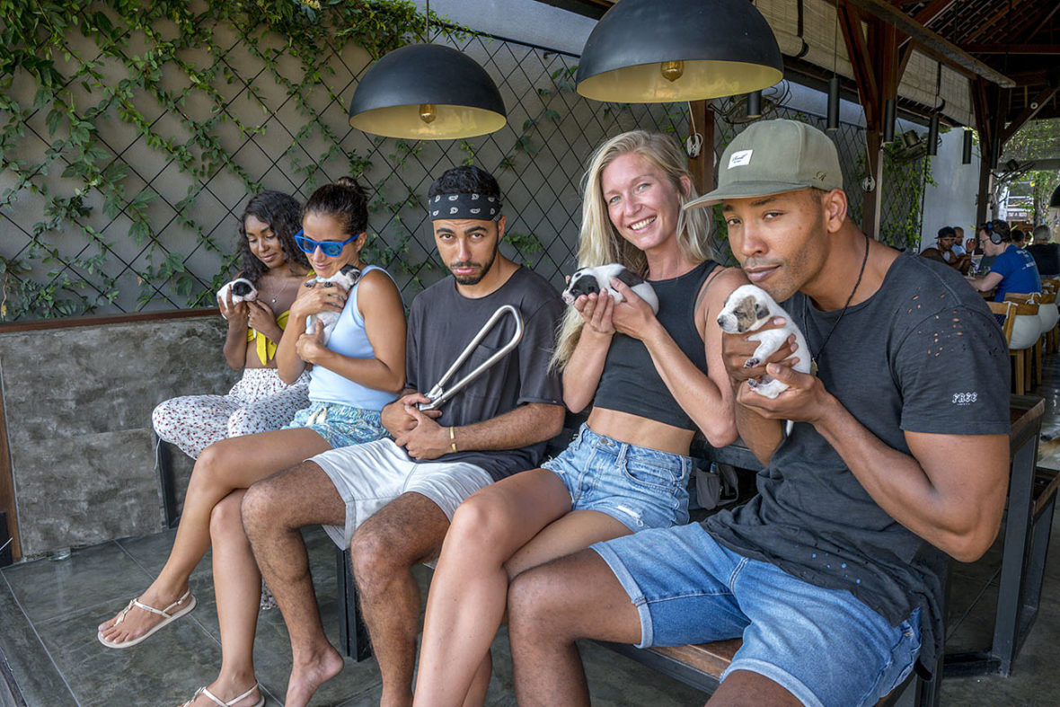 Daia, Emille, Ilsa and Atiba are hapily holding adorable puppies, while Ali is left out holding the NYC Subway Handle at Cafe Cinta Canggu, Bali, Indonesia