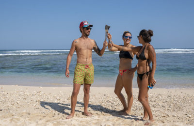 Steven, Emille and Larisa holding the subway handle at Greenbo Beach in Canggu, Bali, Indonesia