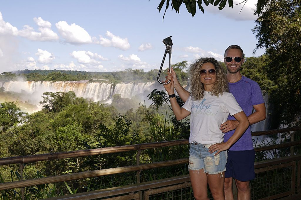 Emille and Dan of NY See You Later holding the NYC Subway Handle at Foz do Iguaçu on the Argentina side, taken with the Sony a7rii and flash